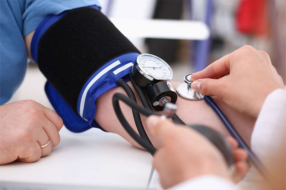 A doctor is checking a little girl's ear.
