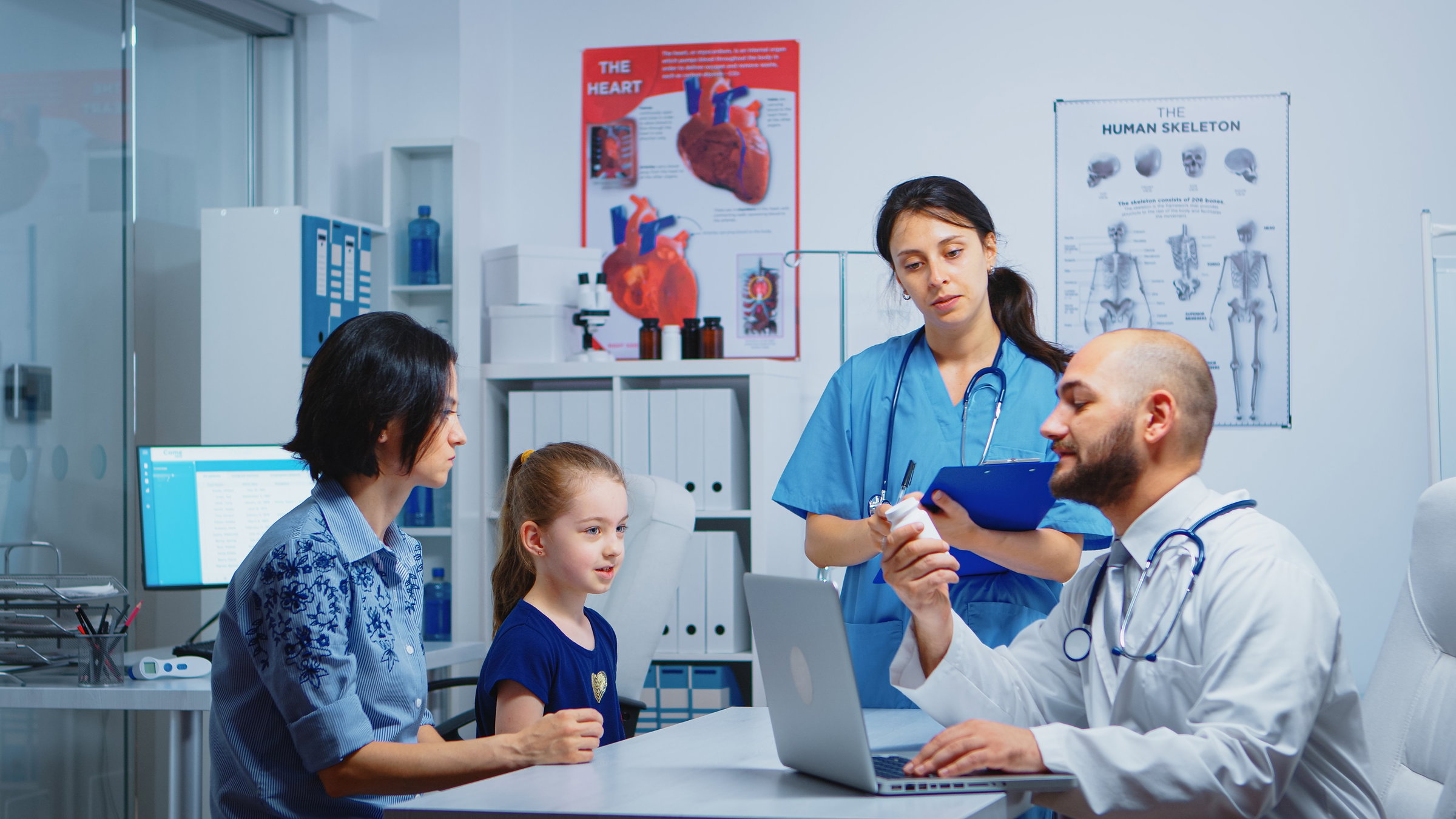 An elder man is carefully listening to his smiling and friendly doctor