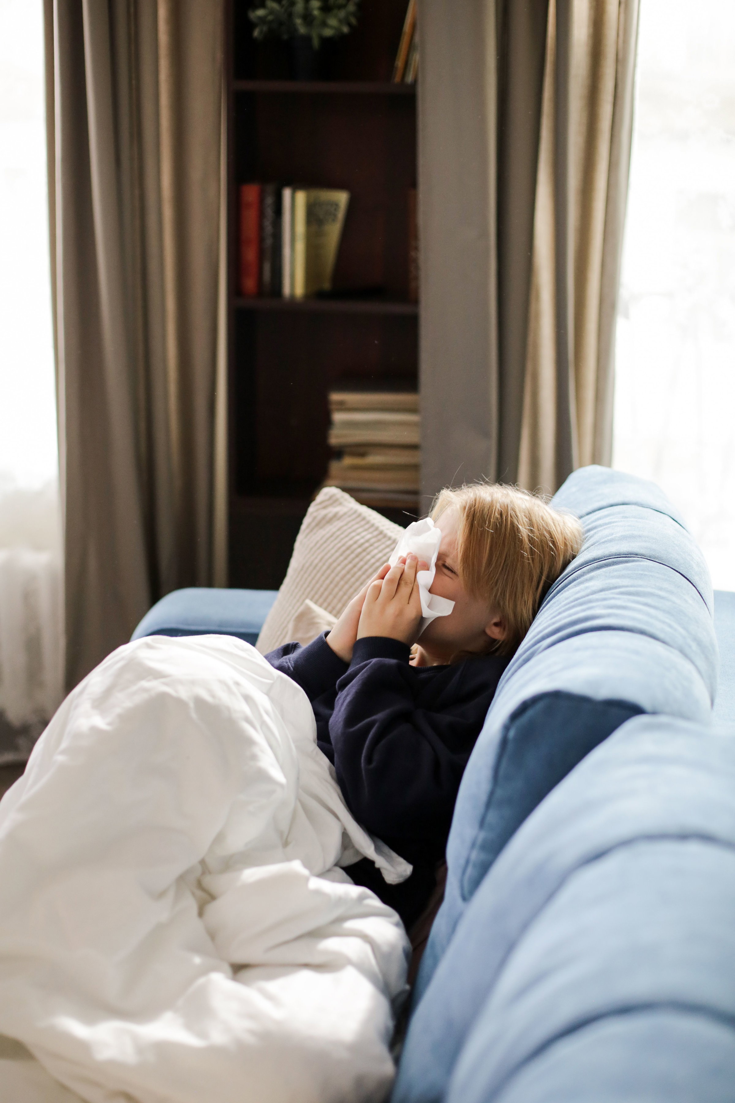 A mom and his child are on a videocall with the primary care physician