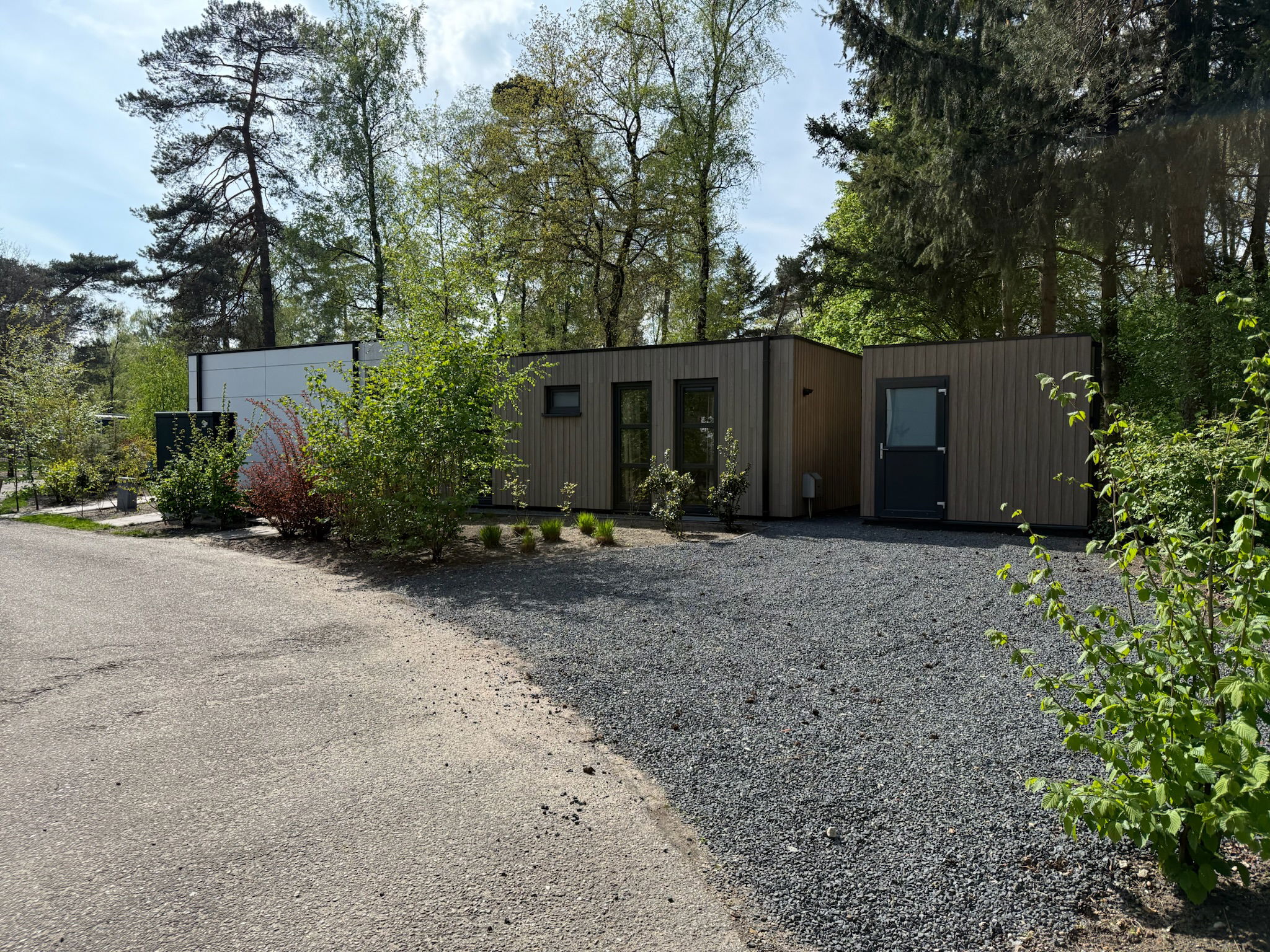 Spacious private parking area for multiple cars or a small camper, with adjacent shed for bicycle storage