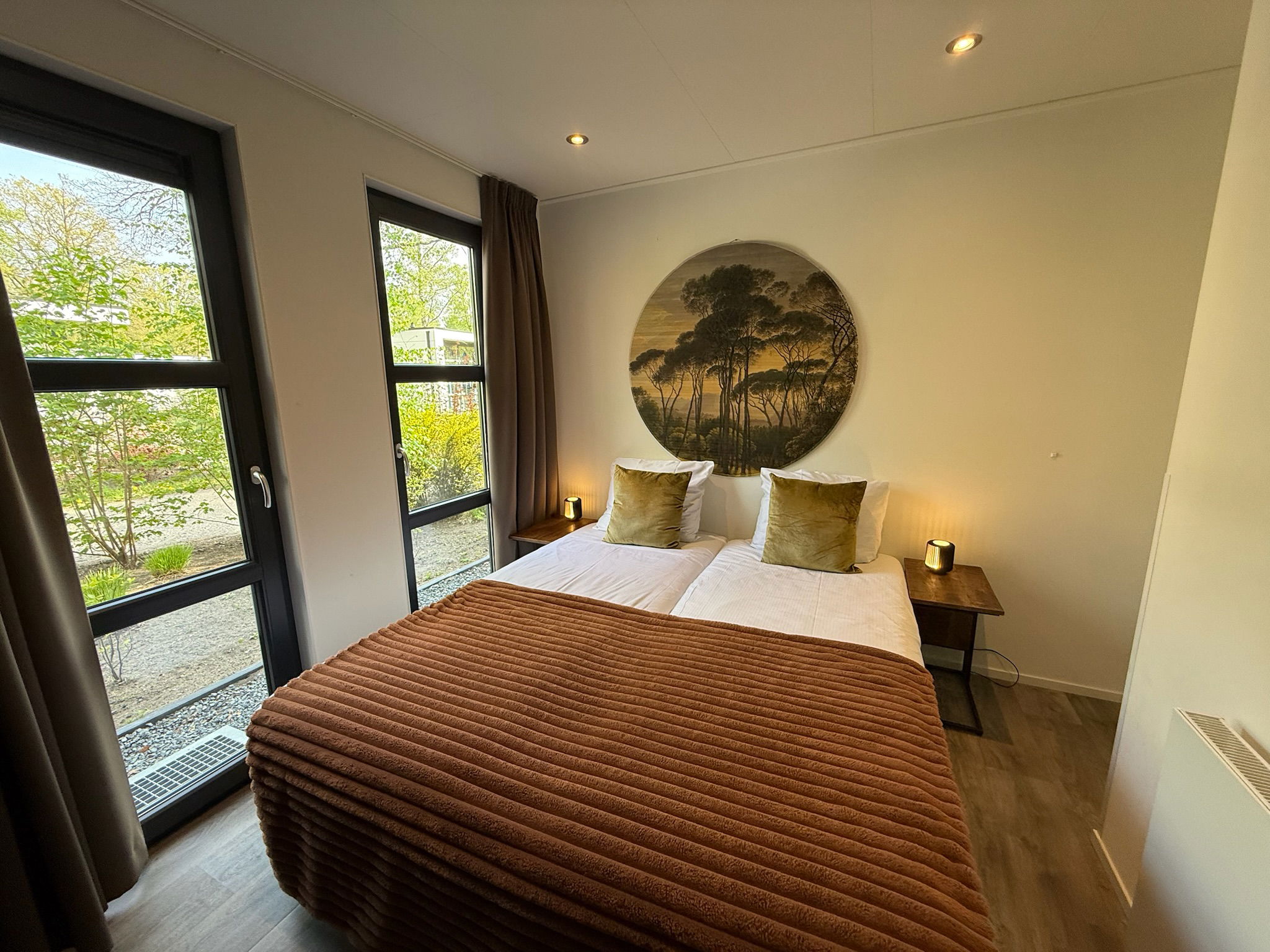 Bright master bedroom with double M Line mattress, soft lighting and modern decor