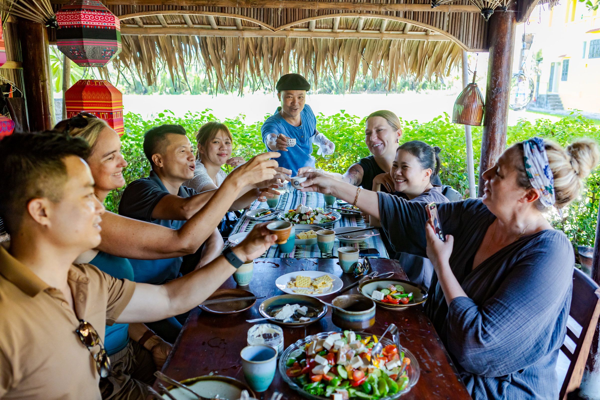 A group sitting at a table in Hoi An during the Modern Culinary Experience. 