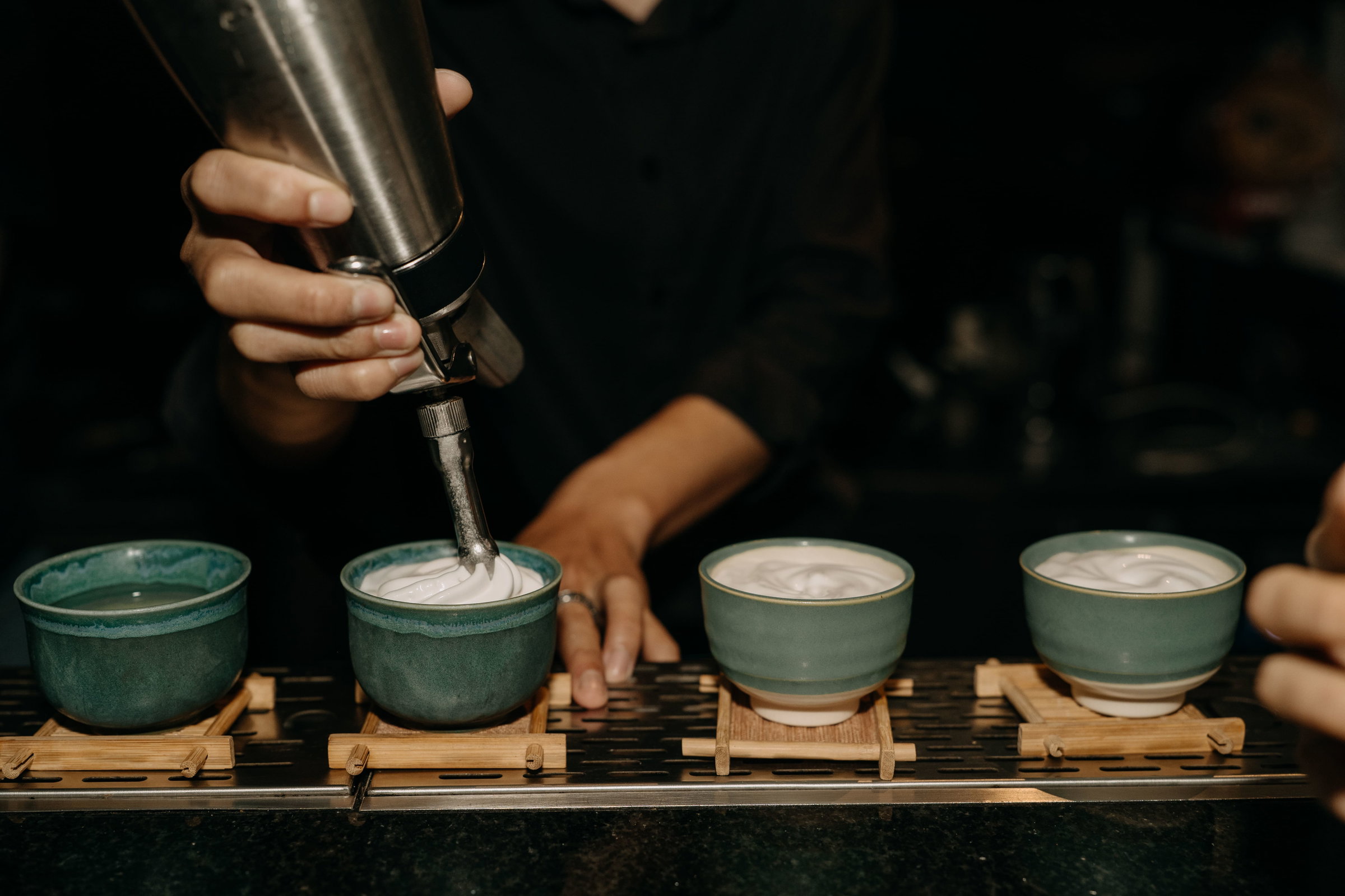 topping up a cocktail with foam 