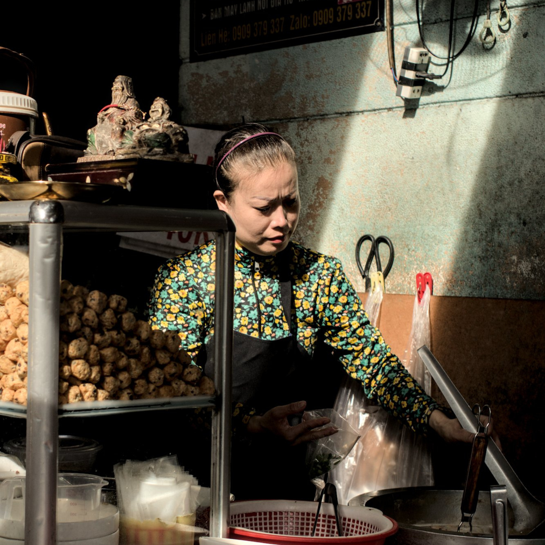 Vietnamese woman working at her street food stand