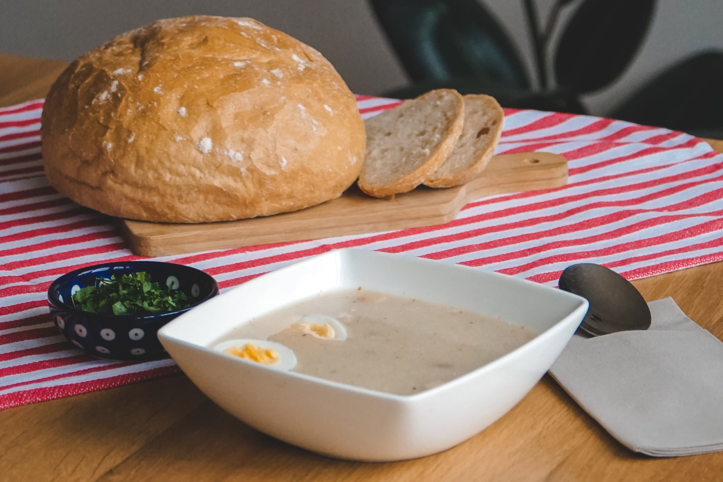 Homemade Polish tasting table with bread, sausage, cheese and pickles during a Warsaw food workshop