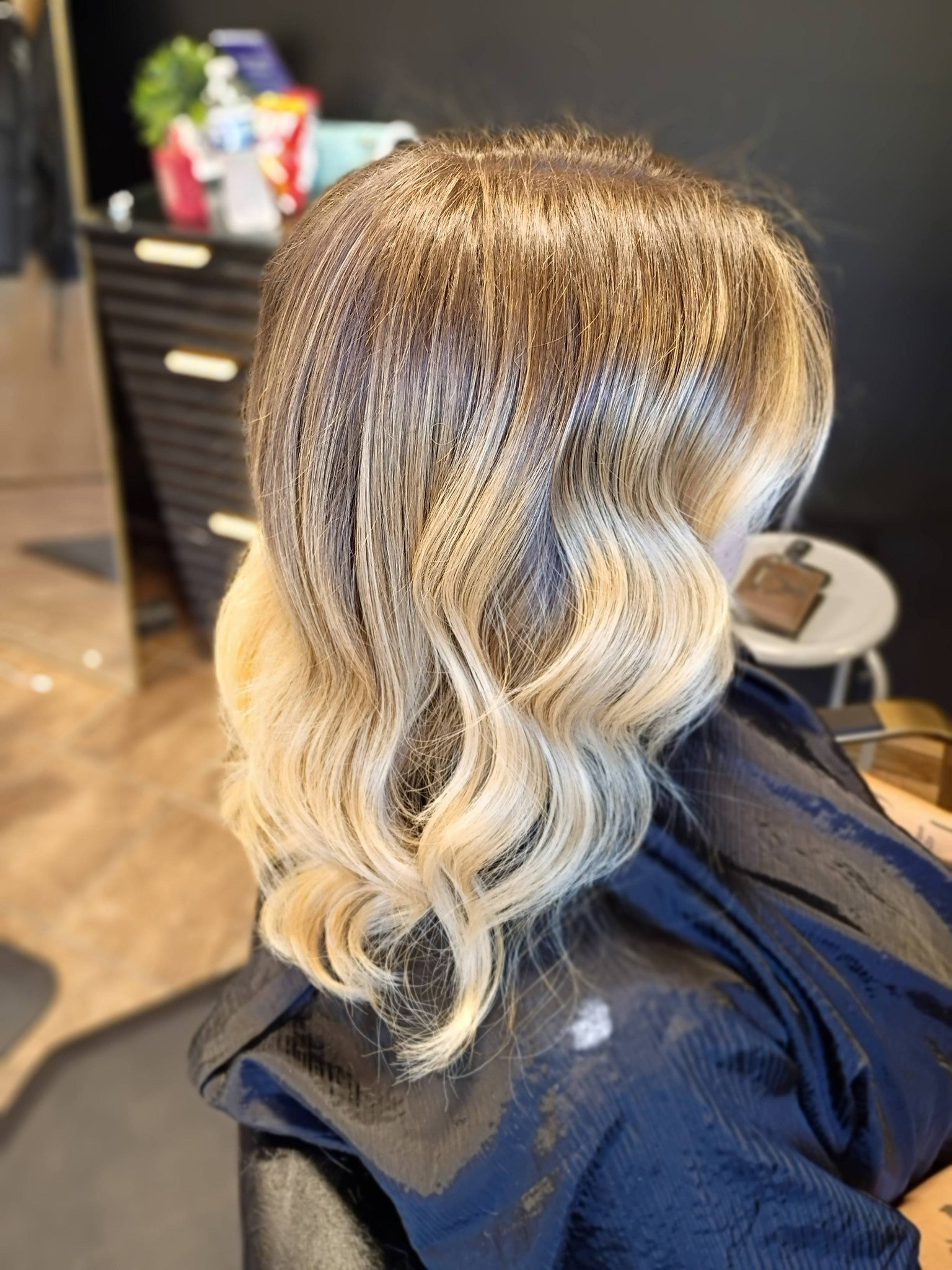 Rooted blonde balayage with soft waves
