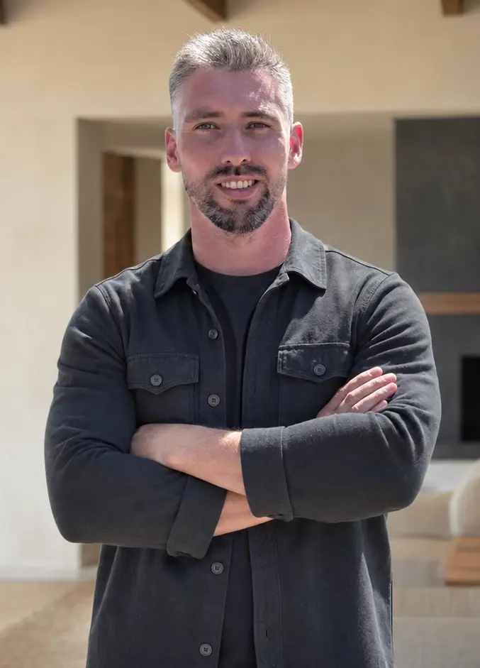 Nick Gray, owner of White Glove Handyman OC, standing in a modern home