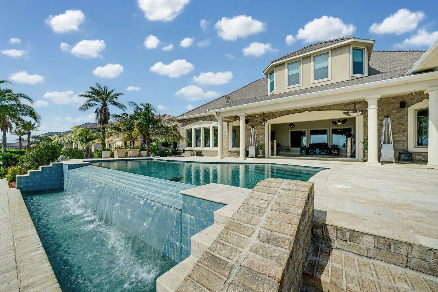 Luxury swimming pool with waterfall at a home in Slidell, Louisiana