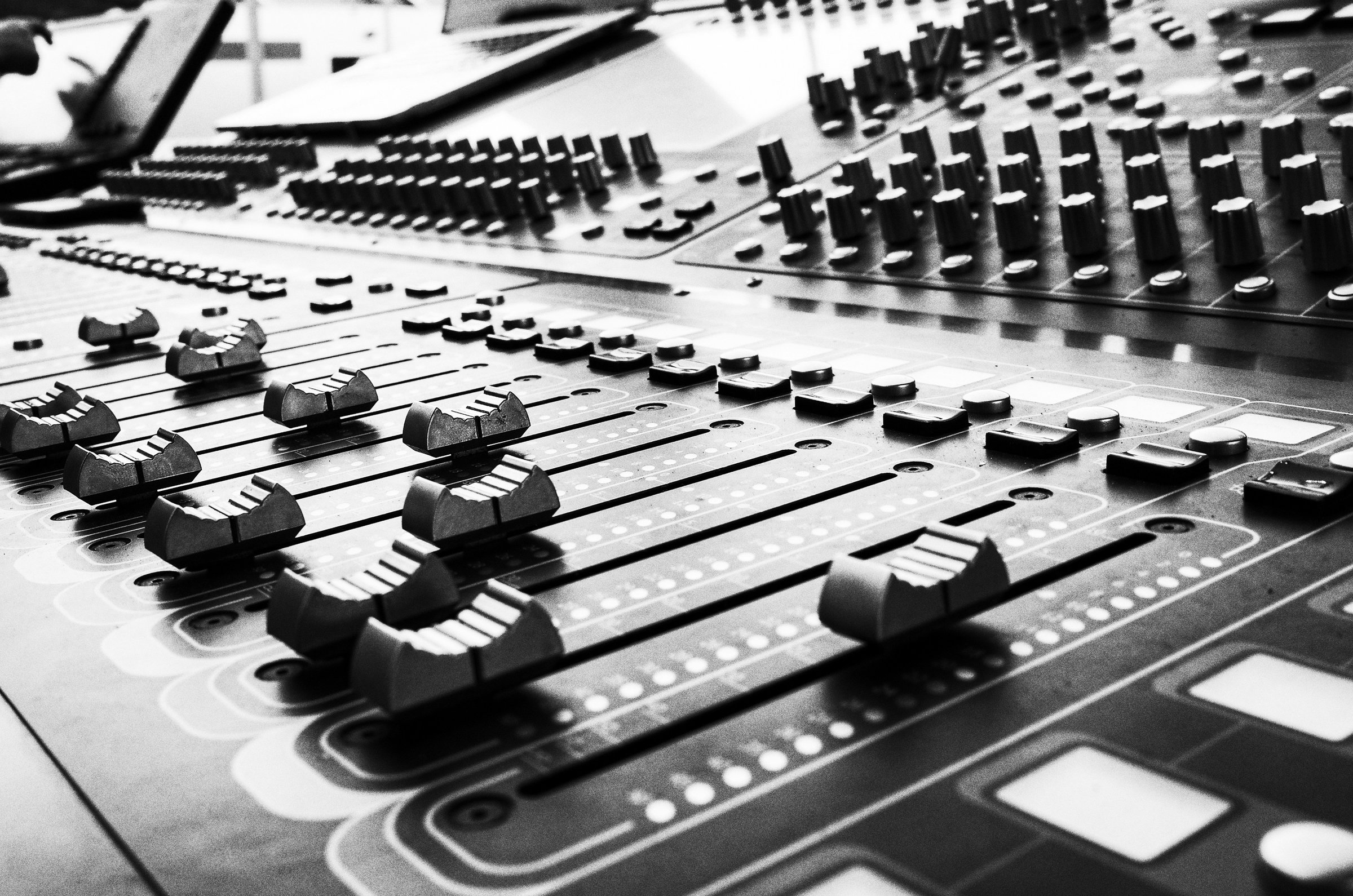 Equipment showcase including SSL mixing console, API preamps, and vintage Neve hardware