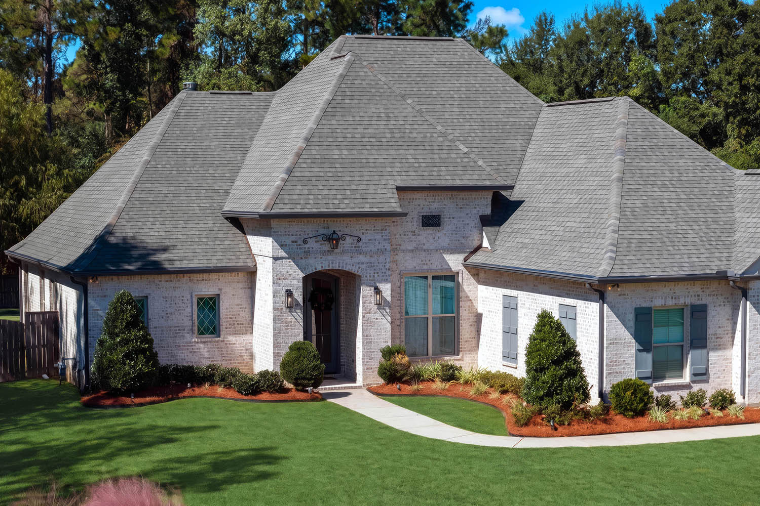 Angled aerial drone view showcasing a residential home's exterior in Mandeville, Louisiana.