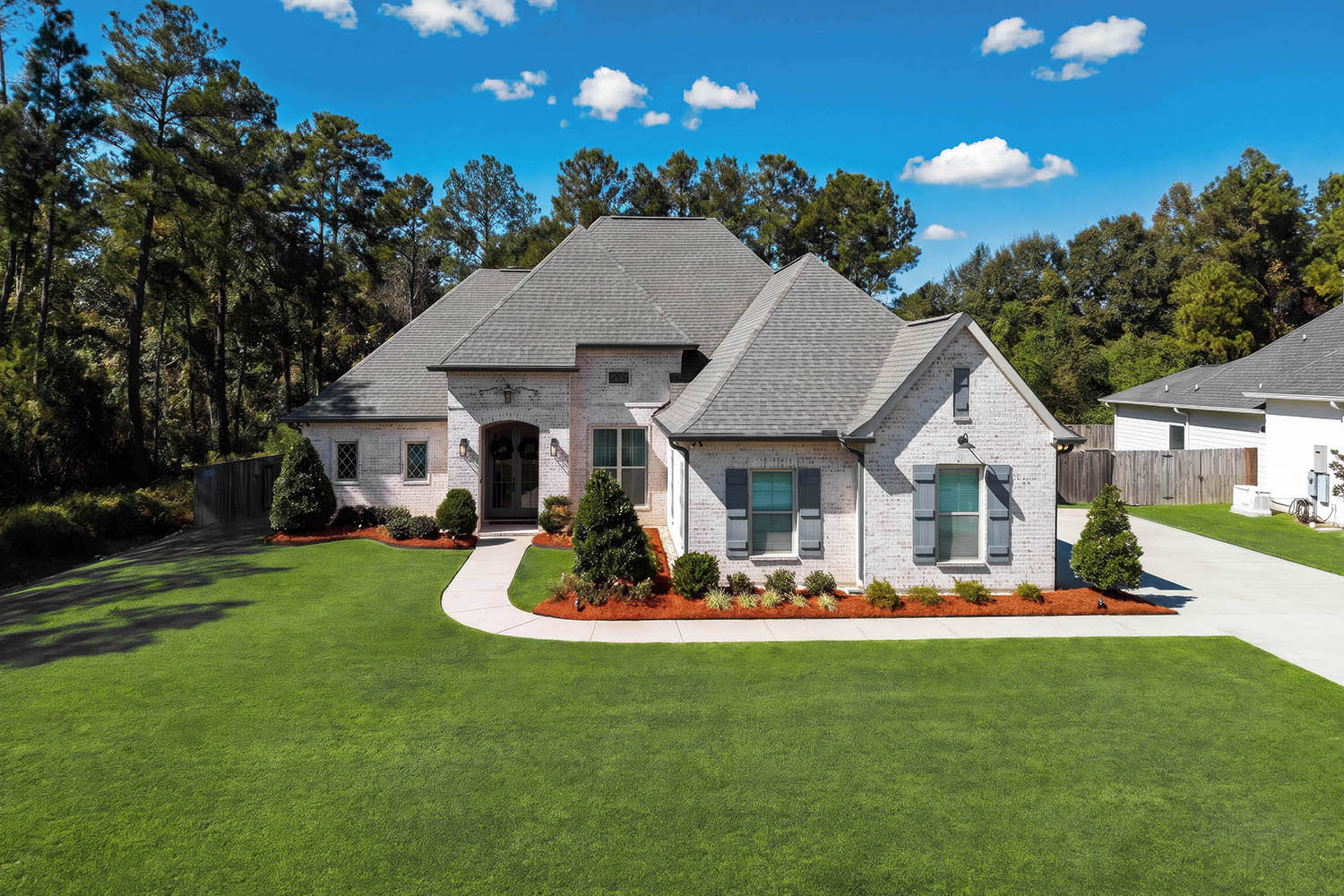 Straight-on aerial drone photograph of a home's exterior in Mandeville, Louisiana, by pompo.media.
